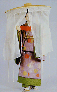 Woman of the upper class of heian era Japan in travelling outfit wearing a very large brimmed hat with veil panels or curtains hanging from the brim.