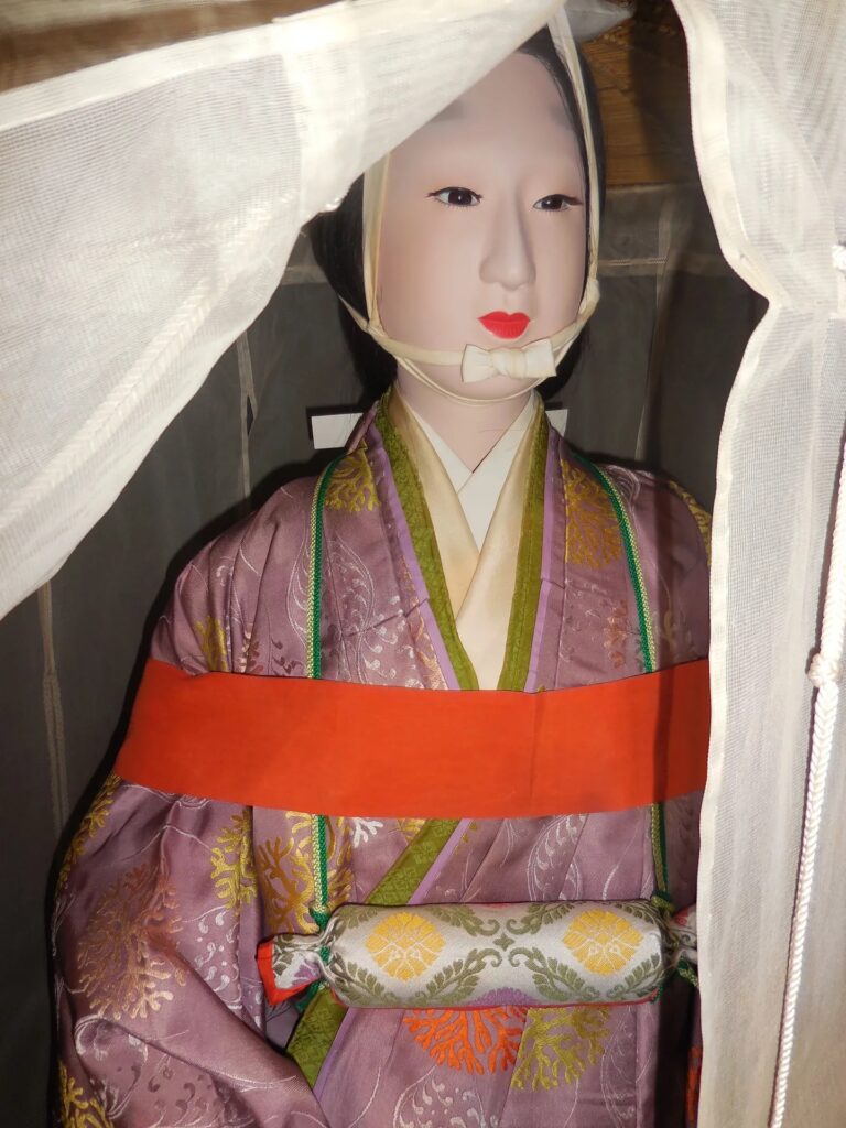 Close up image of a mannequin wearing traditional Japanese dress, a travelling outfit. 
