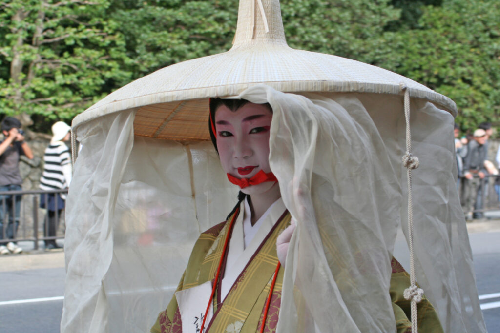 Woman in ichime gasa with mushi no tareginu. (A rush hat with a very large brim circumference that has sheer curtains and decorative cords hanging from it.)  at the Jidai Matsuri 2009